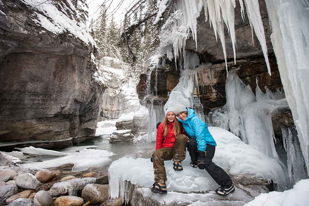 Sitting-Under-Ice-Maligne-Canyon-Jasper-Winter-MaligneAdventures-CR Traveling with your BFF