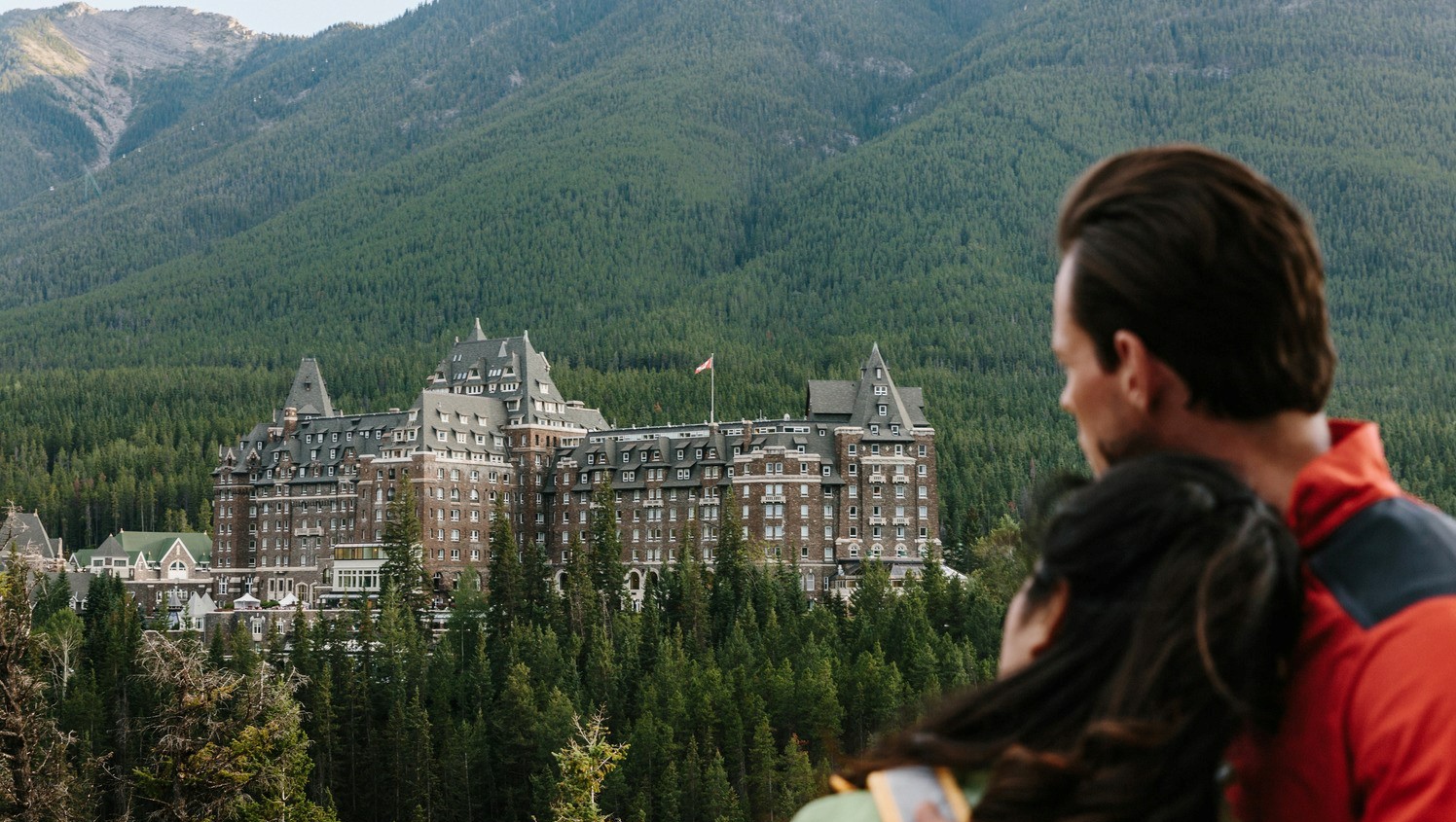 A couple viewing Fairmont Banff Springs from Surprise Corner