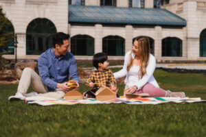 Lake Louise Family Dining- Family of 3 having a picnic at the Fairmont Chateau Lake Louise. Outdoor dining