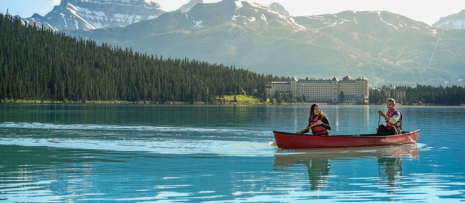 A couple canoeing on Lake Louise at the Fairmont Chateau Lake Louise