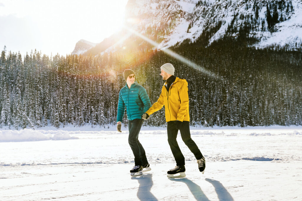 A couple skating over frozen Lake Louise
