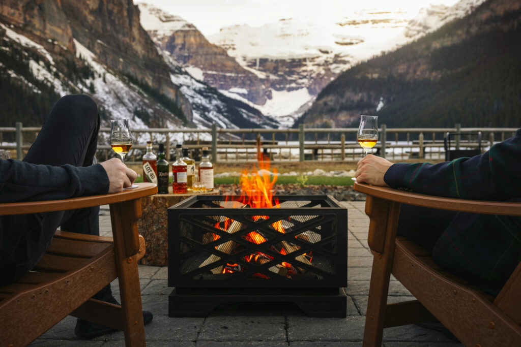Fall campfire with whiskey in front of Lake Louise