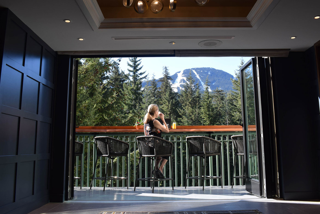 Woman working from Gold Floor Lounge, Fairmont Chateau Whistler