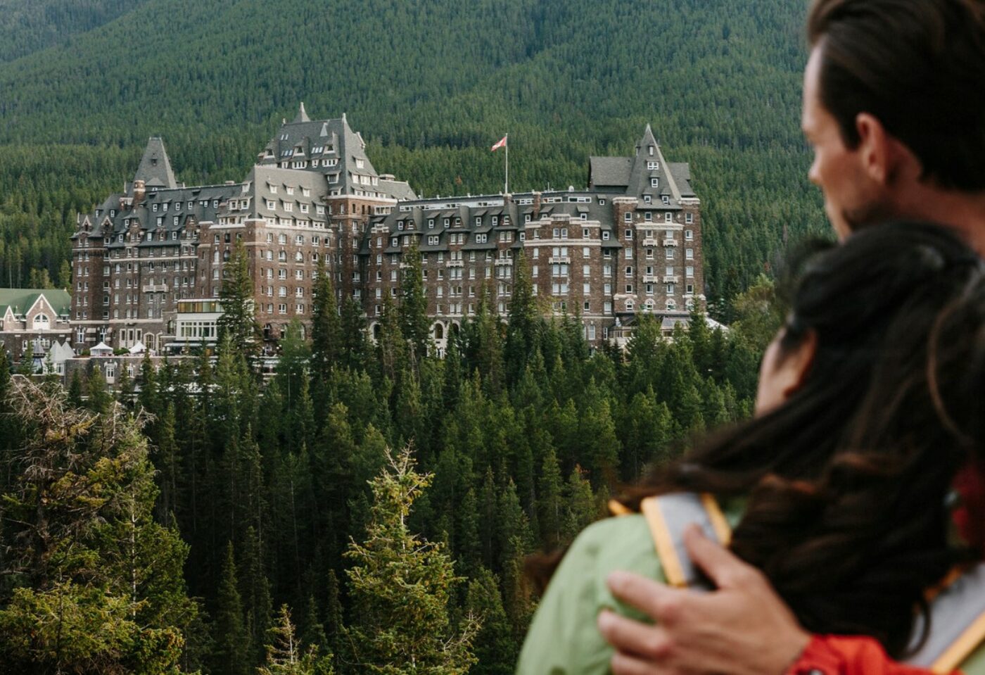 Couple looks longing at Fairmont Banff Springs 