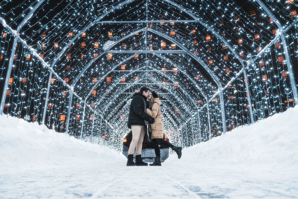 A couple embracing under twinkling lights at Fairmont Chateau Lake Louise