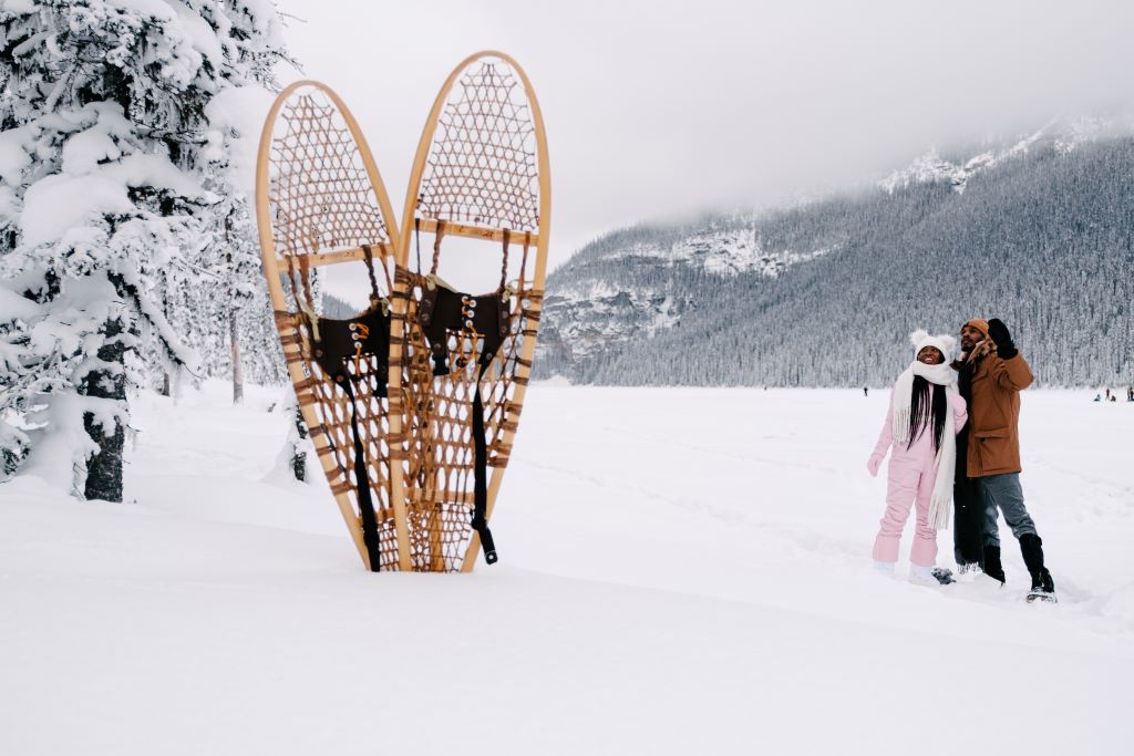 A couple snowshoeing on Lake Louise, Alberta in Winter