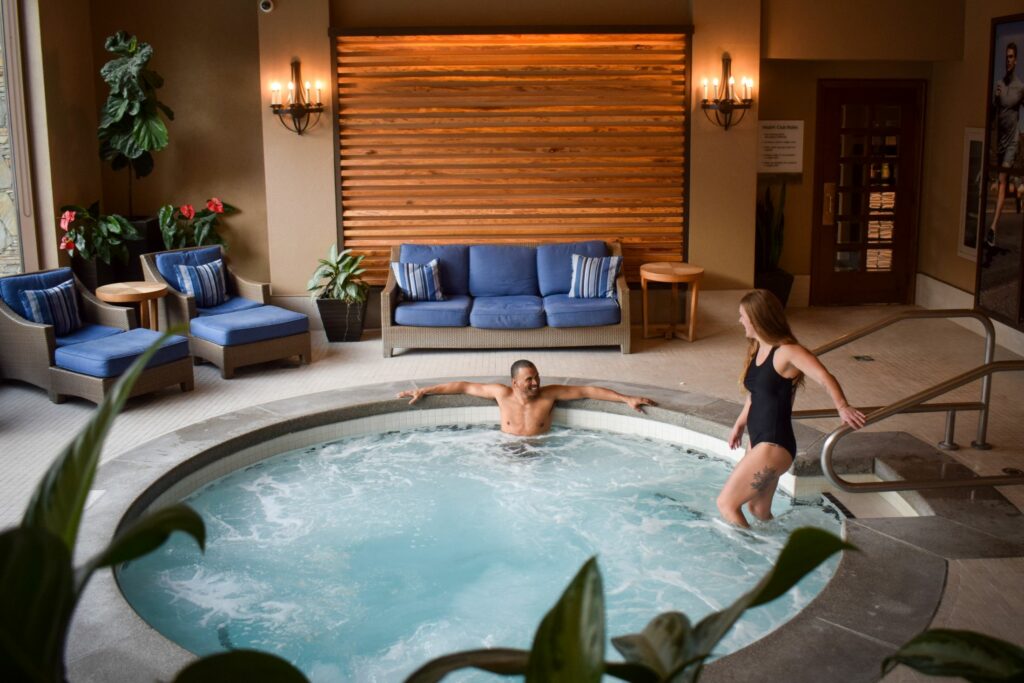 Whistler indoor pool and spa tub, a couple enjoying wellness in Whistler