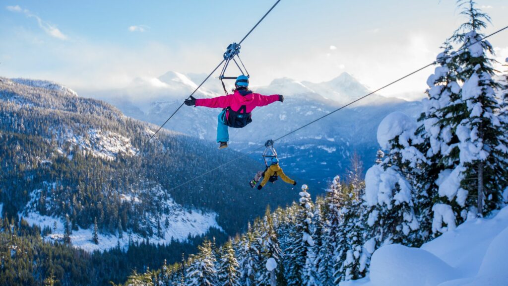 A Couple Dual Ziplining in Whistler in Winter, photo by The Adventure Group 
