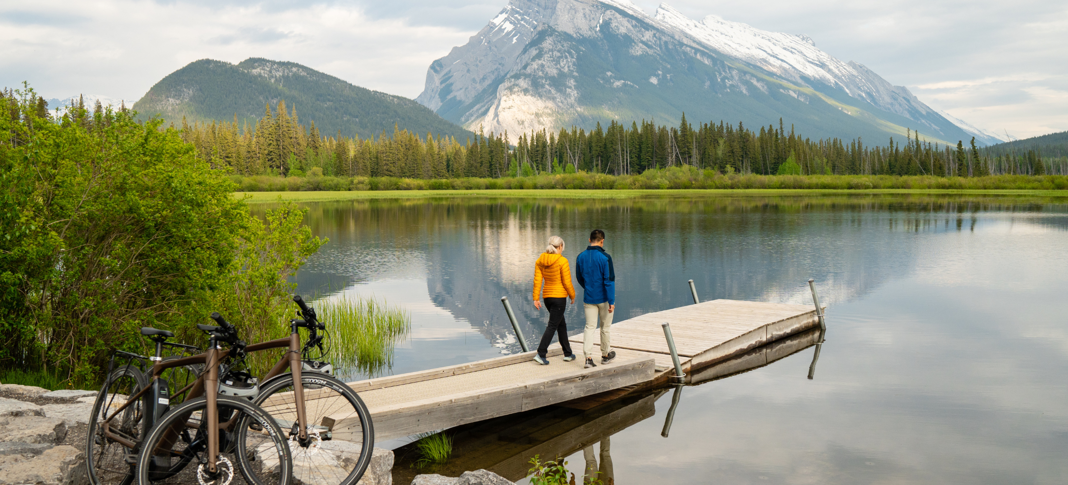 A couple at Vermillion Lakes Dock in Banff National Park. Photo by Travel Alberta / ROAM Creative