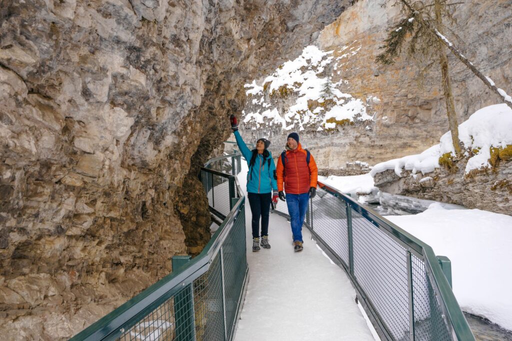 A couple exploring Johnston Canyon in Early Spring/late Winter. Photo by Travel Alberta / Stevin Tuchiwsky