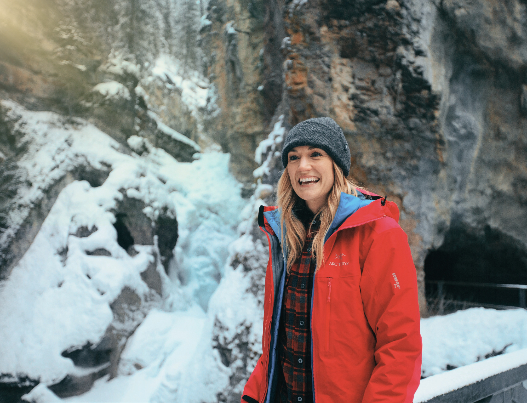 A woman at Johnston Canyon's lower frozen waterfalls. Photo by Jake Dyson.