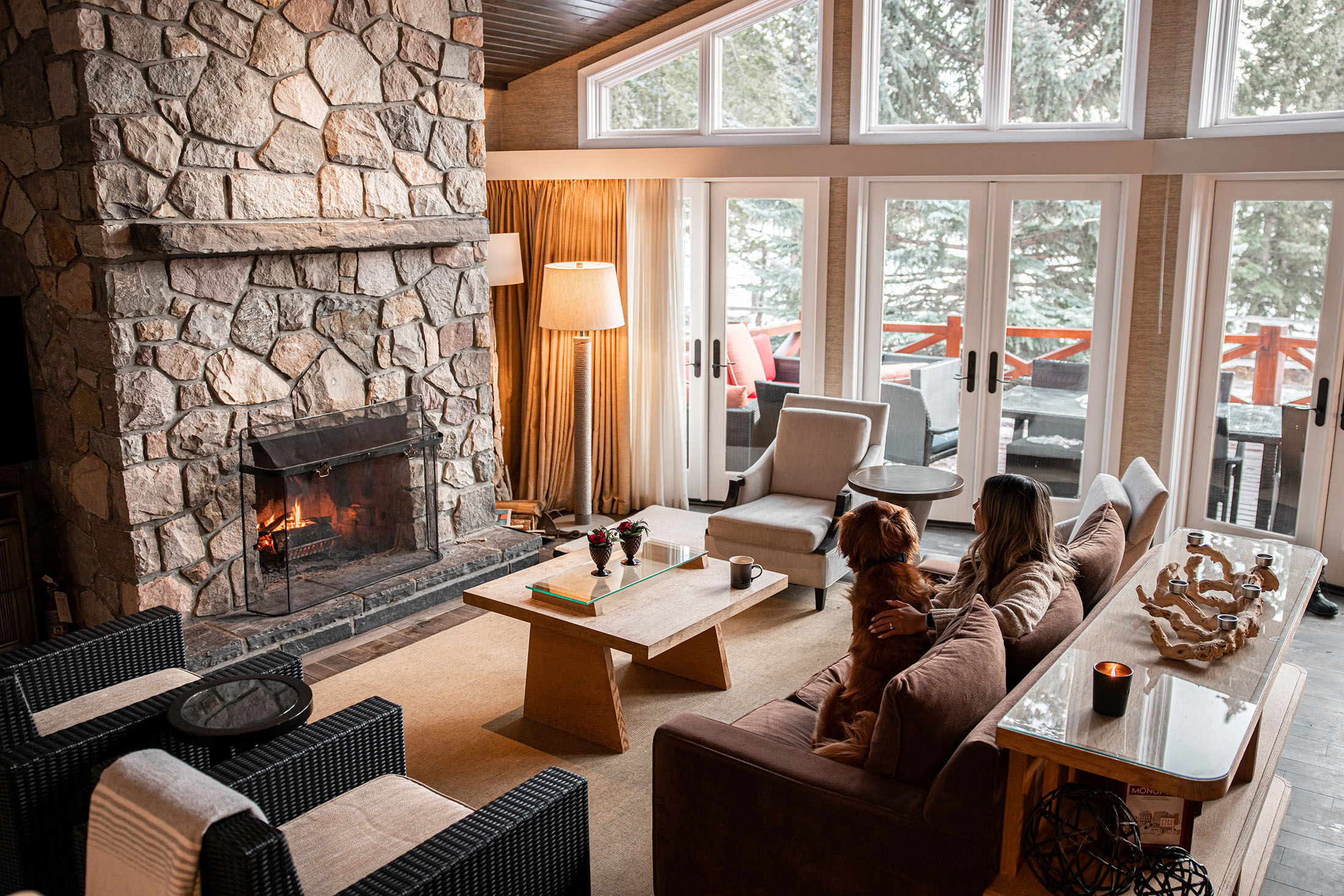 Roaring fire in front of dog and owner in a Signature Cabin in Jasper National Park